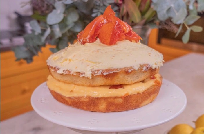 This special two-layer macadamia cake features lemon-myrtle syrup, lemon curd, orange buttercream and crystallised grapefruit.